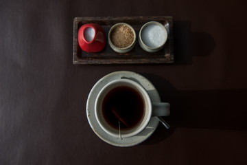 Obraz na płótnie Canvas Hot tea served in a mug with milk and sugar