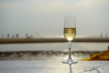 champagne glass with blurred sea and sky background