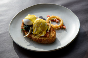 Poached egg with hollandaise sauce on toast with salmon ham and spinach