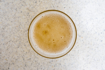 Glass of beer top view with beautiful beer bubbles texture