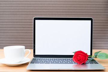 Red rose and coffee cup with laptop mockup on wood