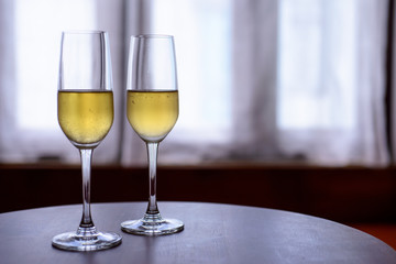 champagne glass with blurred curtain background