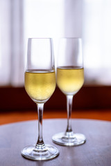 champagne glass with blurred curtain background