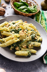 Penne pasta with spinach, gorgonzola cheese and walnuts