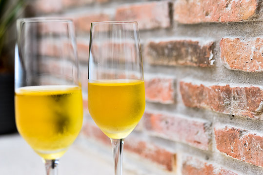 champagne glass with blurred brick background