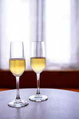 champagne glass with blurred curtain background