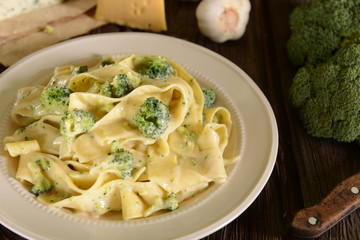 Tagliatelle pasta with cheese sauce and broccoli