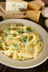 Tagliatelle pasta with cheese sauce and broccoli