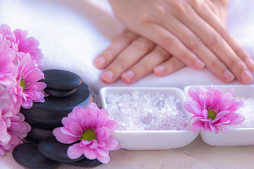 Obraz na płótnie Canvas Spa treatment and product for female feet and manicure nails spa with rock and pink flower, copy space, select focus, Thailand