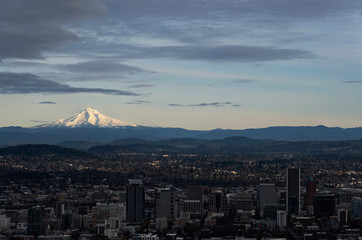 Cityscape of Portland Oregon with amazing clouds and Mount Hood in a distance in Oregon