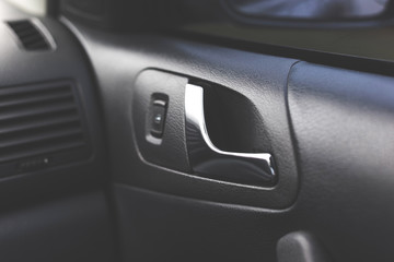 Obraz premium Handle opening the car door. Car interior.
