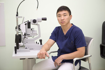 Male doctor ophthalmologist in the workplace