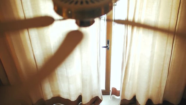 ceiling fan on the background of the curtain. view from above