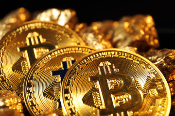 Bitcoins and gold nuggets, closeup