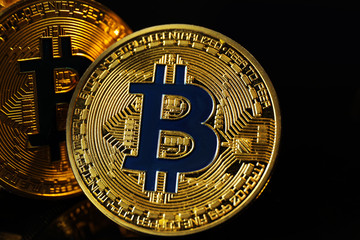 Bitcoins on black background, closeup