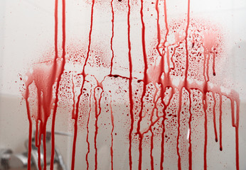 Blood streaks on glass door of shower cabin