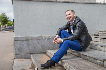 Portrait of handsome young man on the steps