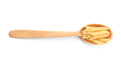 Spoon with uncooked penne pasta on white background