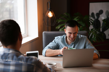 Young colleagues working together in cafe