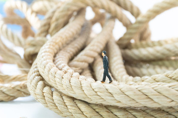 businessman walking on the long rope close up