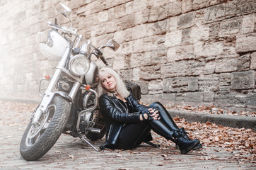 Fototapeta na wymiar Beautiful biker woman outdoor with motorcycle. 