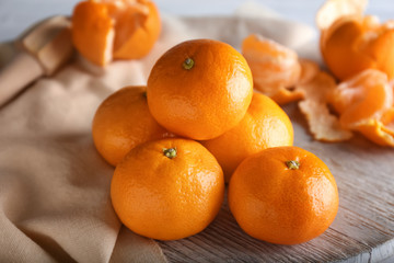 Ripe sweet tangerines on wooden table