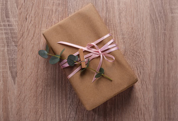 Festive gift box on wooden background