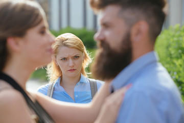 She has reason to be jealous. Unhappy girl feeling jealous. Romantic couple of man and woman dating. Bearded man cheating his woman with another girl. Jealous woman look at couple in love on street