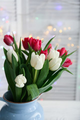 Bouquet of beautiful tulips in vase on table