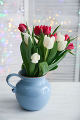 Bouquet of beautiful tulips in vase on table