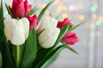 Bouquet of beautiful tulips against defocused lights