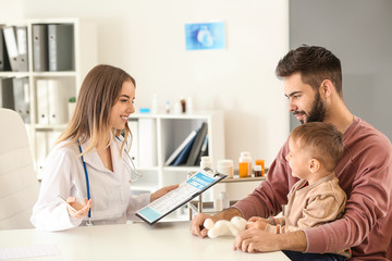 Young father with his little son visiting doctor in clinic