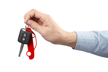 Hand holding a car key on white background