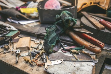 A place for horror movies, like a maniac's lair. Dirty gloomy messy garage, where parts, construction tools lying around. Different parts of the equipment, vehicles.