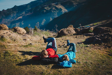 father and son relax on travel in mountains