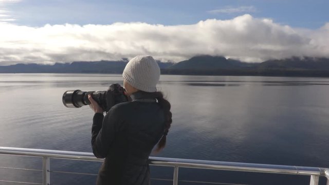 Alaska tourist wildlife photographer enjoying travel vacation cruise in Misty Fiords National Monument (aka Misty Fjords) taking pictures photographing the travel adventure in Alaska.