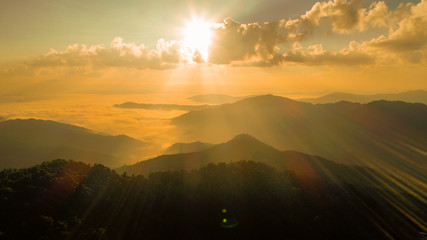 Naklejka na ściany i meble Sunrise over the mountain landscape, A beautiful sun rays with clouds 