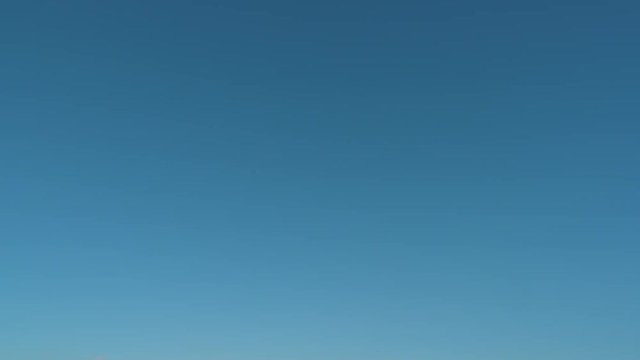 Pan Down: Blue Sky and a Town