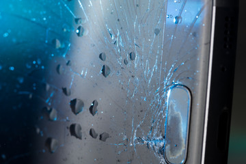 Broken smartphone screen, cracks and shattered glass under various eels
