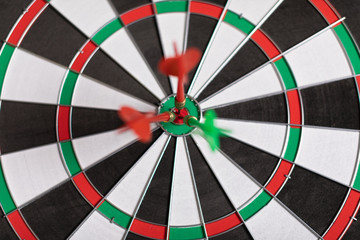 Three Darts hit red target on the target right close-up