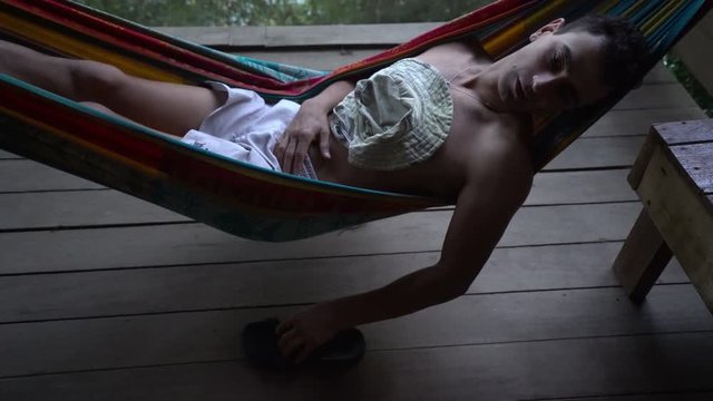 man in hammock laying alone abandoned and getting mad distracted, loneliness mentally ill