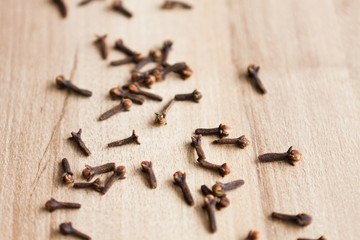 Cloves on wood background.