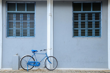 Fototapeta na wymiar old bicycle standing near the windows, old bicycle standing near the door