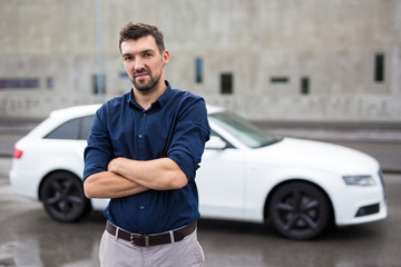 portrait of handsome man and his car