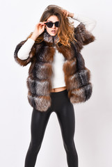 Female brown fur coat. Fur store model enjoy warm in soft fluffy coat with collar. Woman wear...