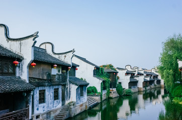 Fototapeta na wymiar Traditional Chinese black and white houses by river, in downtown Jiaxing, China
