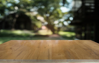 Empty dark wooden table in front of abstract blurred bokeh background of restaurant . can be used for display or montage your products.Mock up for space.