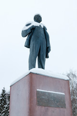 Monument to Lenin with a crap head, covered with snow against the sky, view from below. Winter, Veliky Ustyug, Vologda Region, Russia.