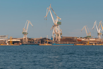 Obraz premium dockyard in Pula with cranes while loading a ship, industry