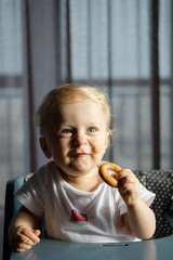 Feeding a baby in a highchair. Food Dirty Kid